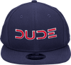 Front view of the Navy & Red, Mesh Snapback, a navy hat with a red DUDE logo